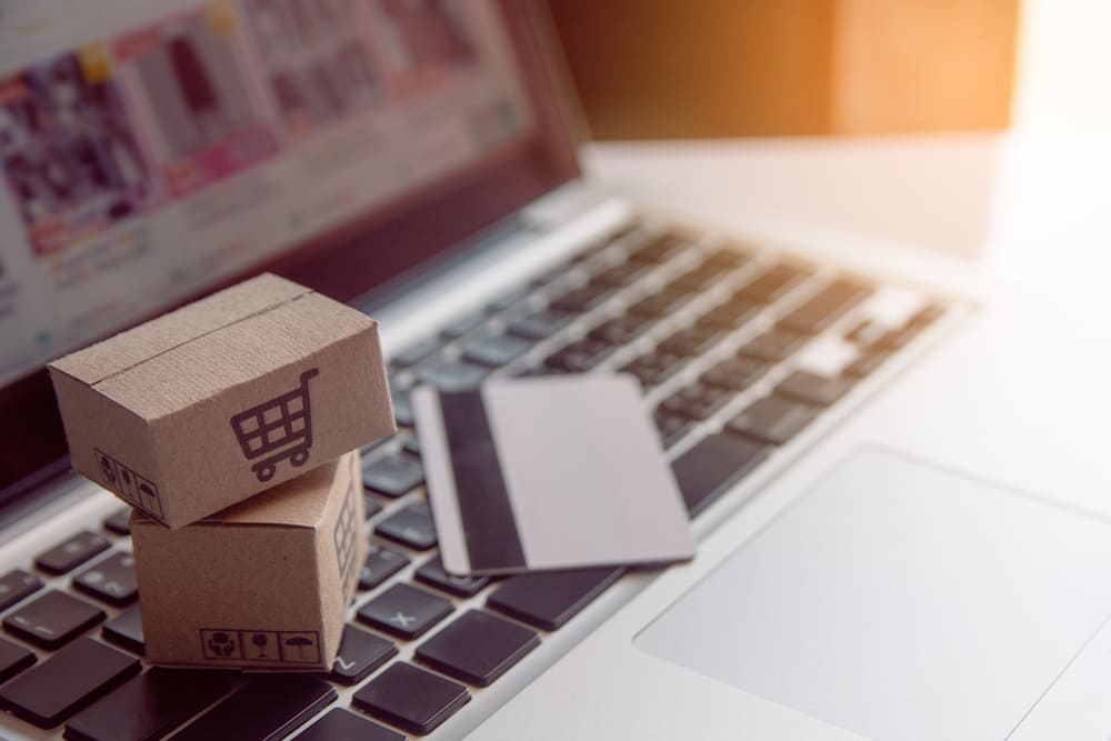 ecpmmerce site with packages over keyboard with credit card